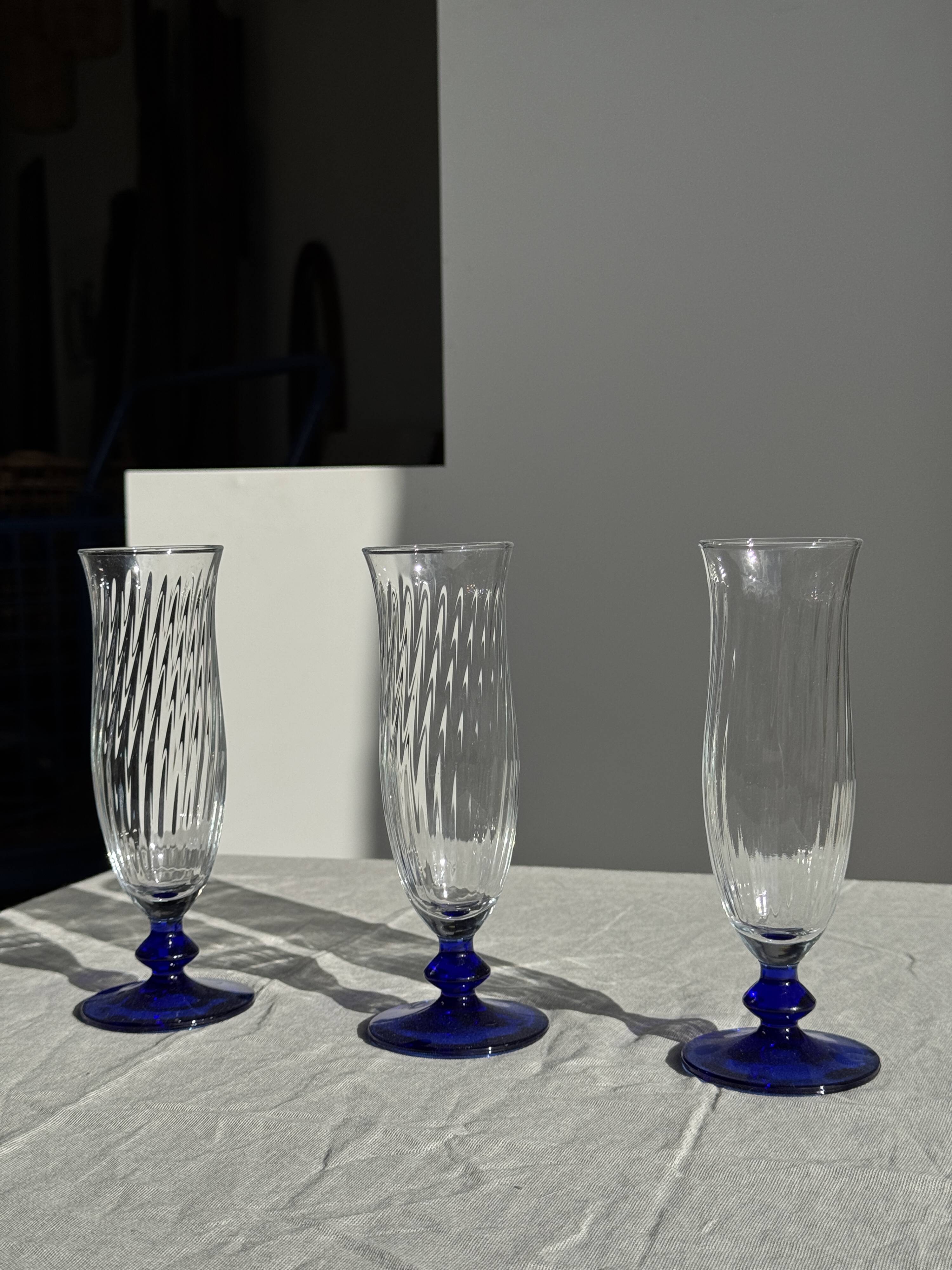 Set of 6 blue-footed champagne flutes; 3 pairs of designs.