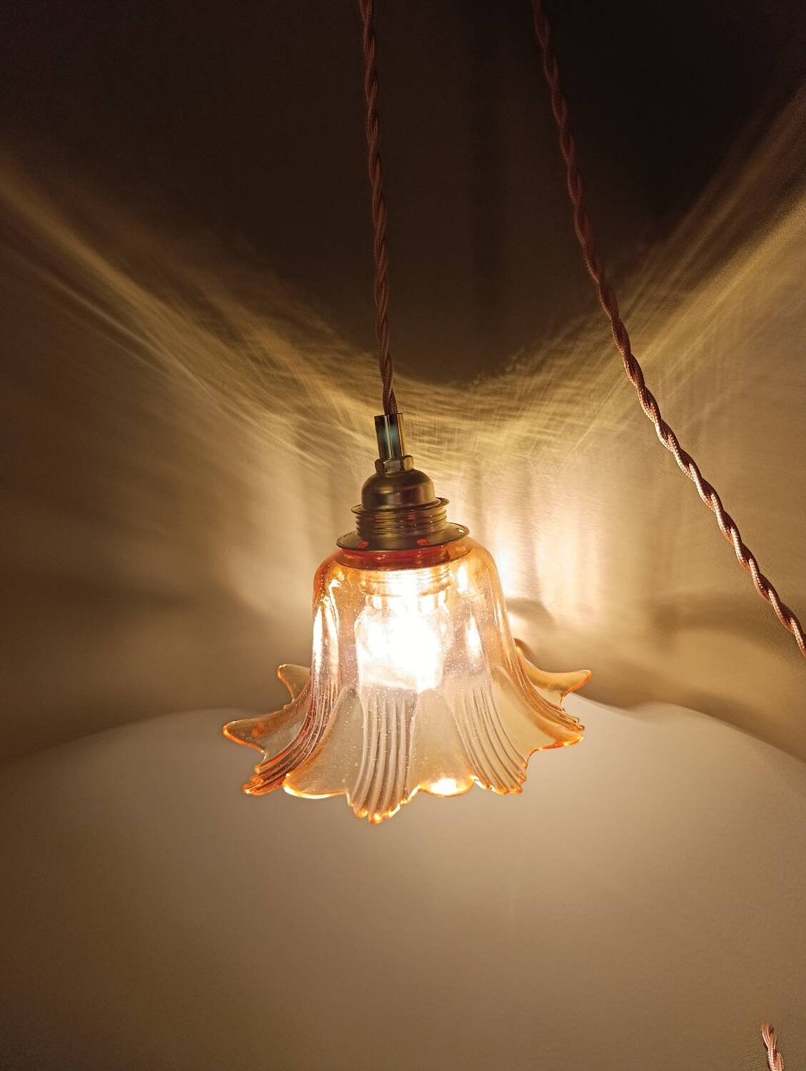 Amber tulip glass portable lamp, golden braided cord.