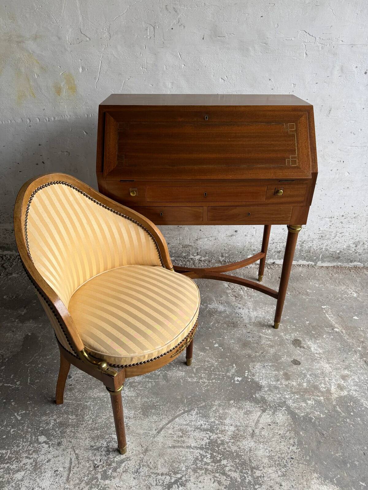 DeCoene antique wood writing desk with beige striped upholstered chair, brass-accented classic set