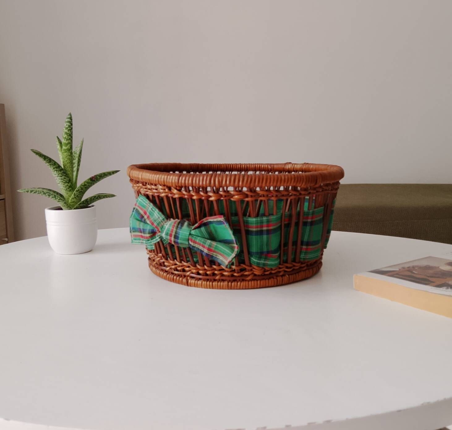 Vintage wicker and rattan basket with tartan fabric.