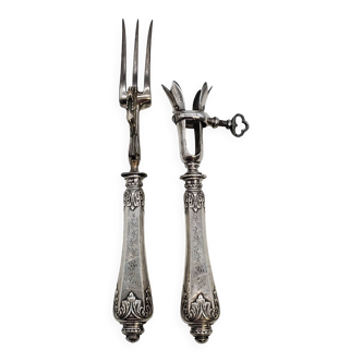 Set of serving forks and silver-plated leg of lamb fork.