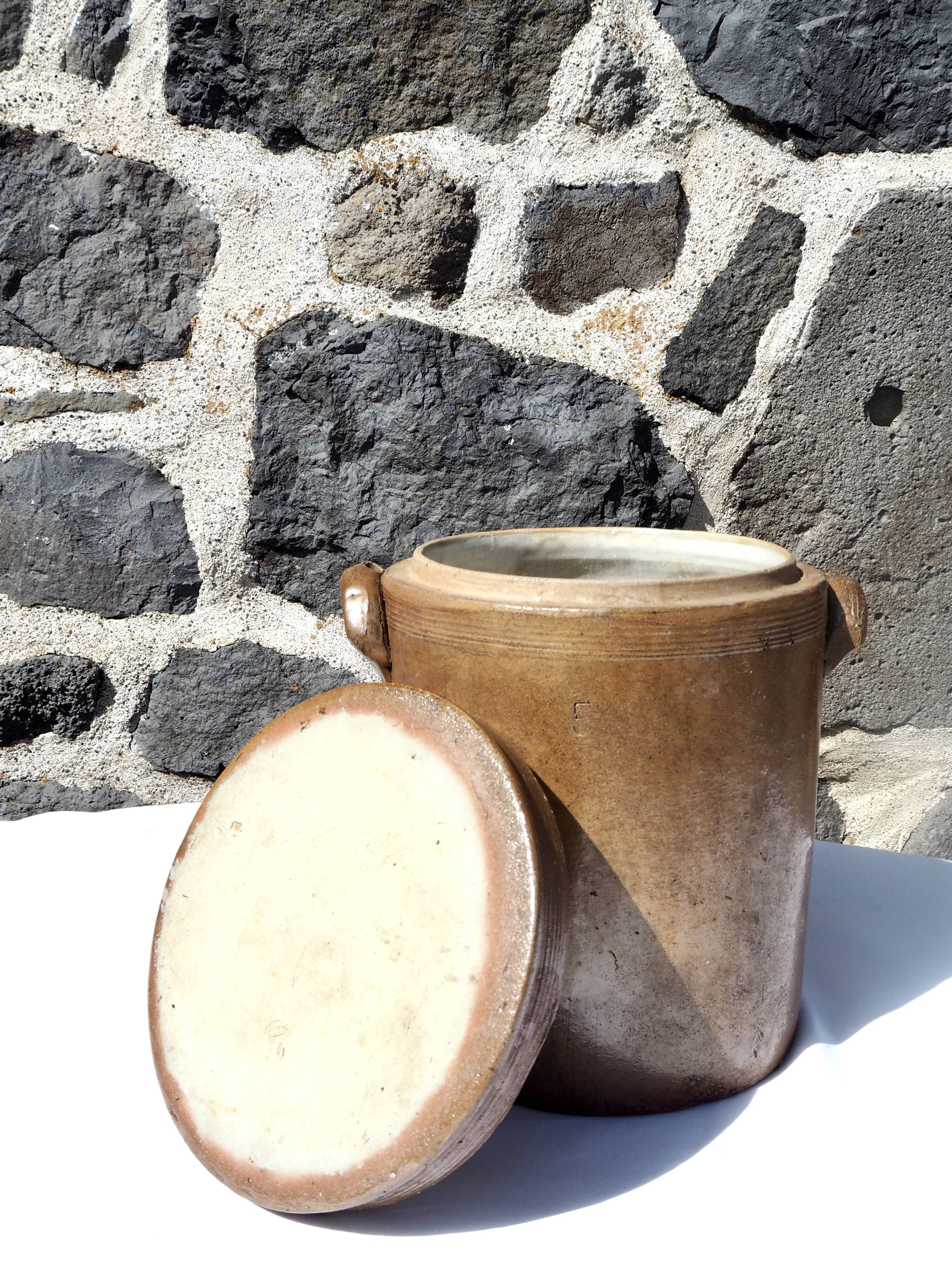 Trio of stoneware pots with lids