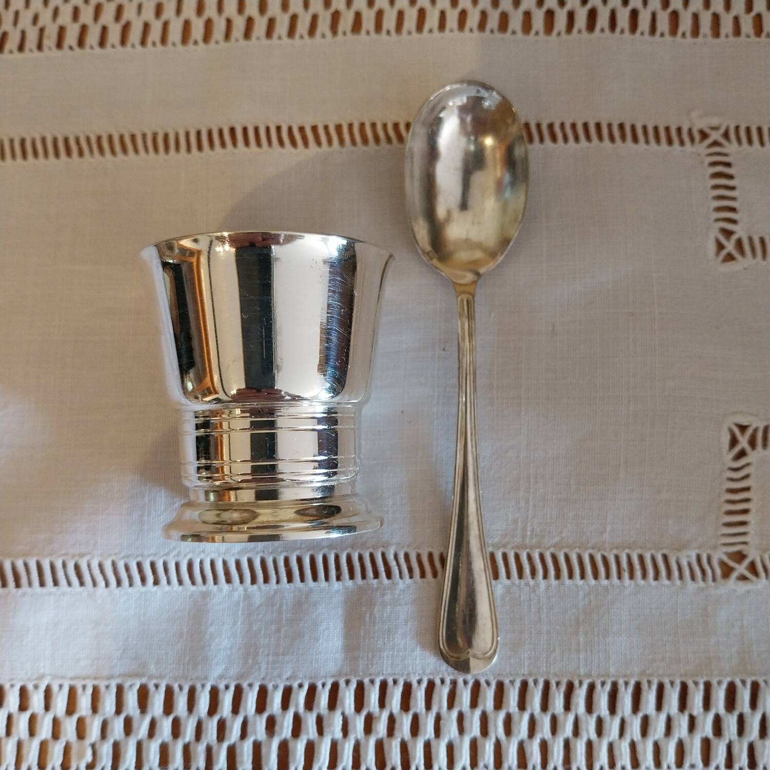 Egg cup and spoon in silver metal