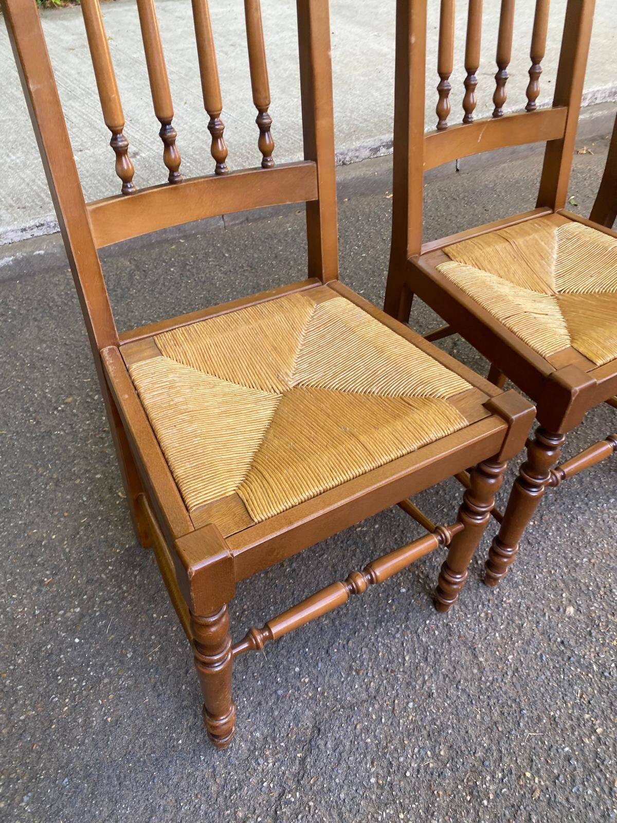 Solid wood chair with a straw seat and carved bar backrest.
