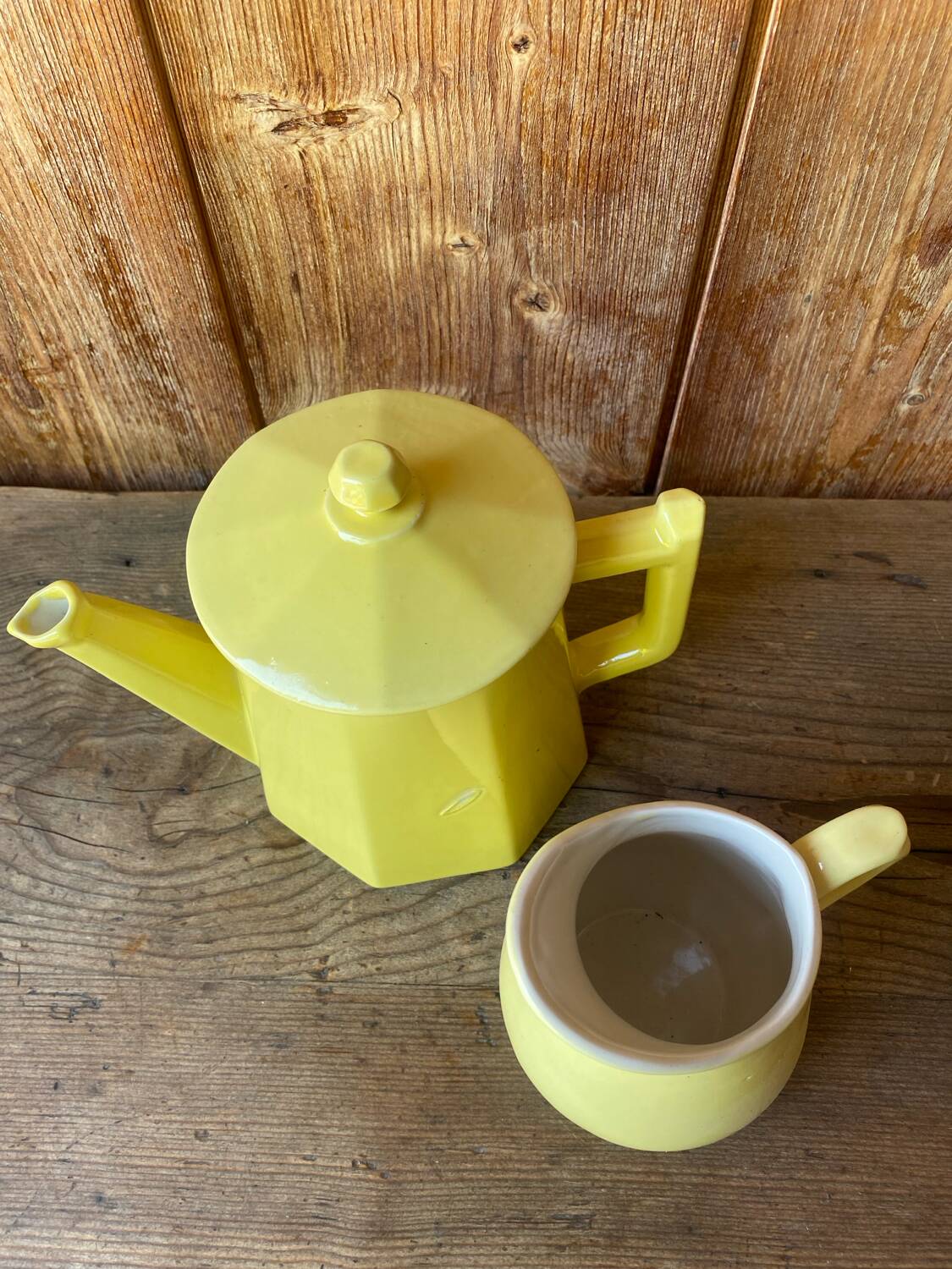 Vintage yellow ceramic teapot and milk jug.
