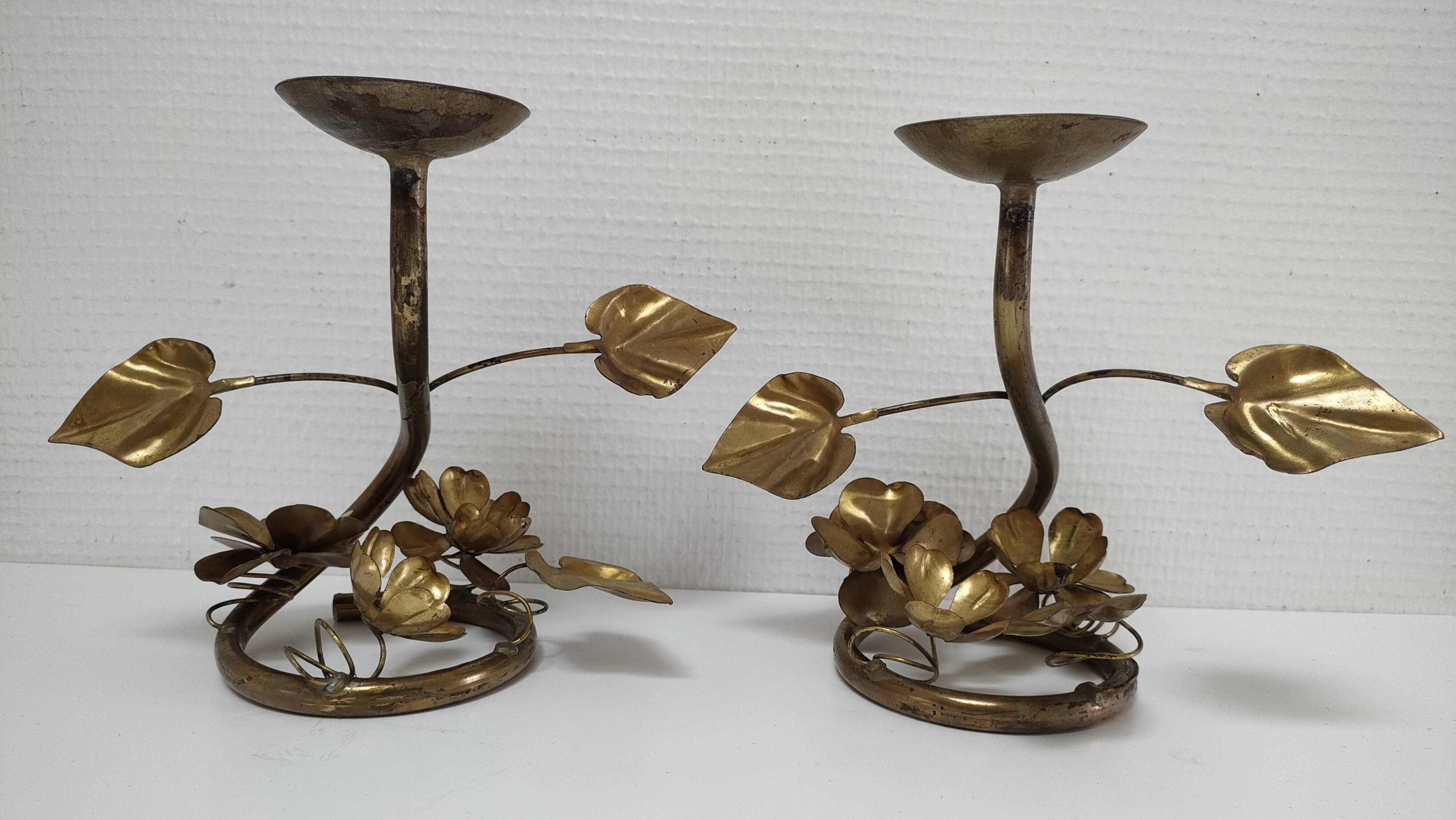 Pair of brass candle holders decorated with patinated metal flowers