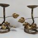Pair of brass candle holders decorated with patinated metal flowers