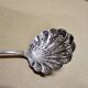 Service spoon cut out of silver metal