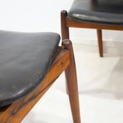 Set of four Arne Vodder chairs in hardwood and black leather.