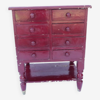 Commode vintage en bois massif rouge bordeaux.