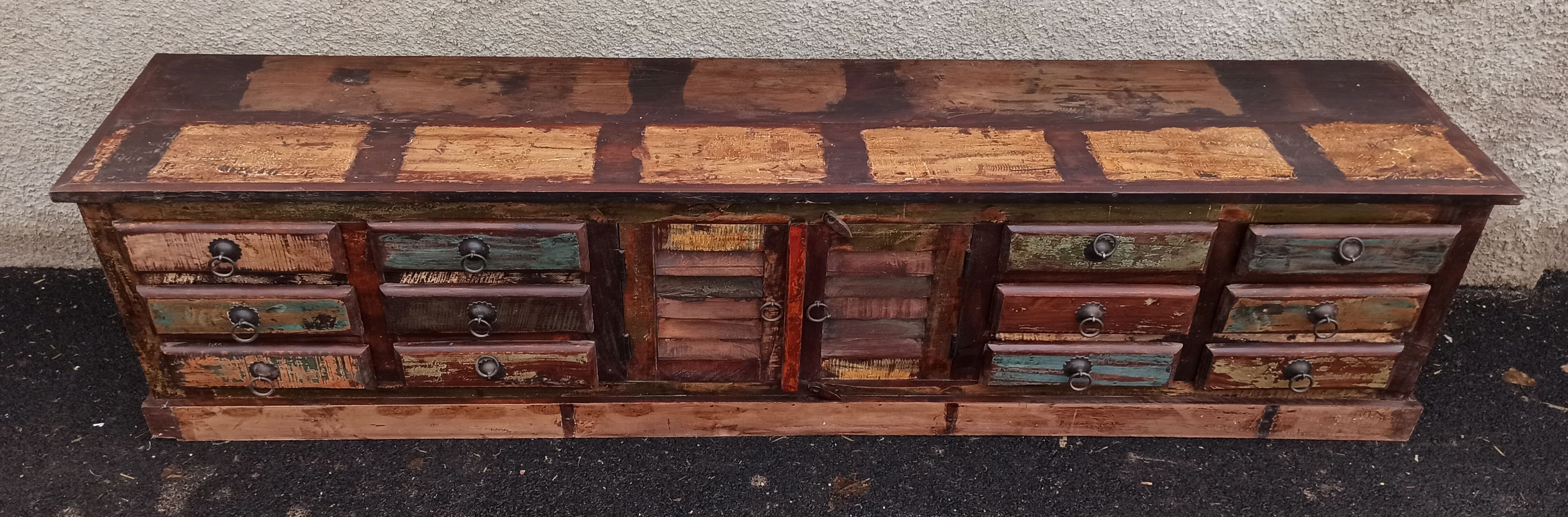 Furniture low in colorful wood. 12 drawers and 1 door