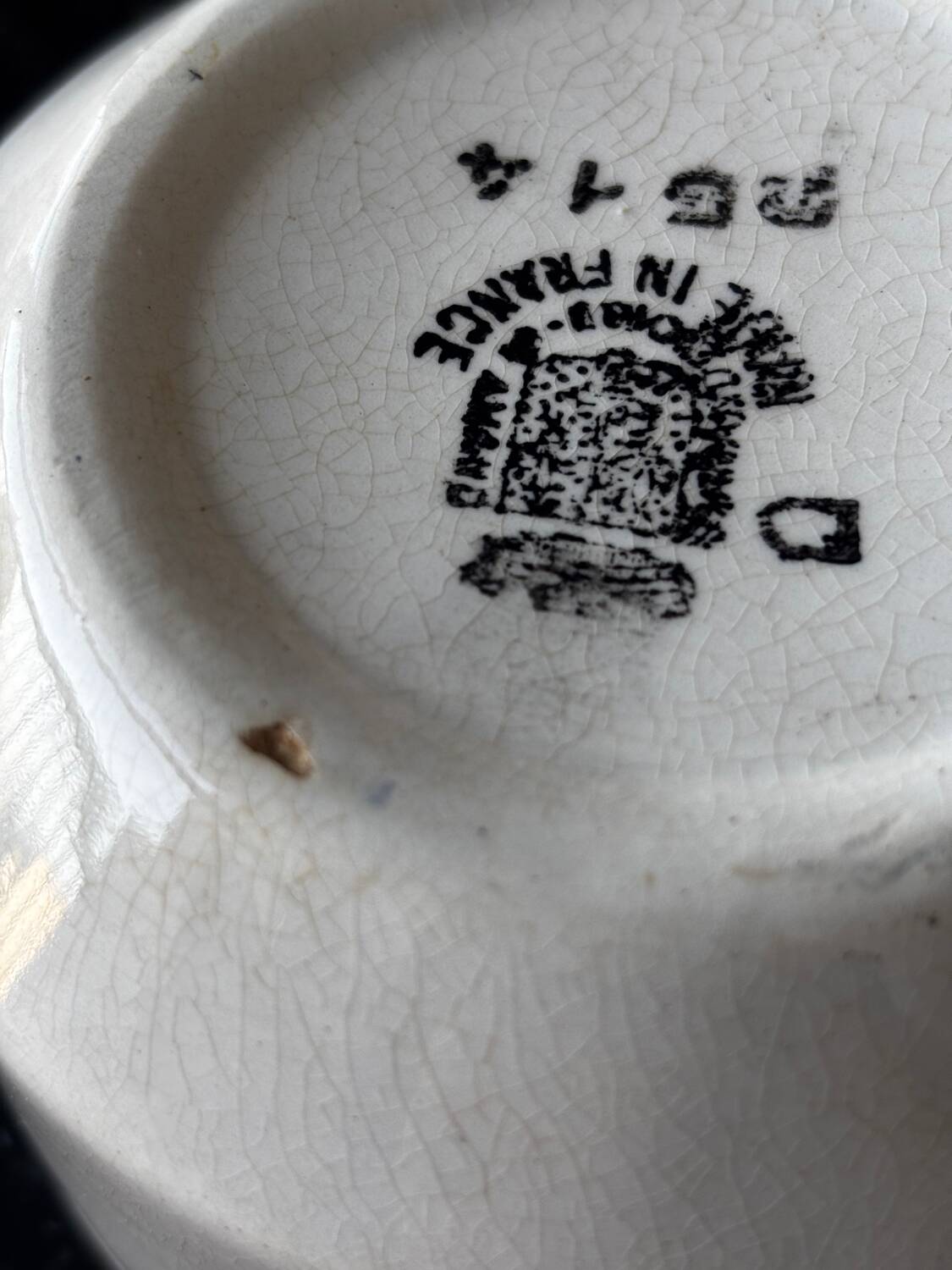 Vintage old sauceboat with pink flowers in St Amand