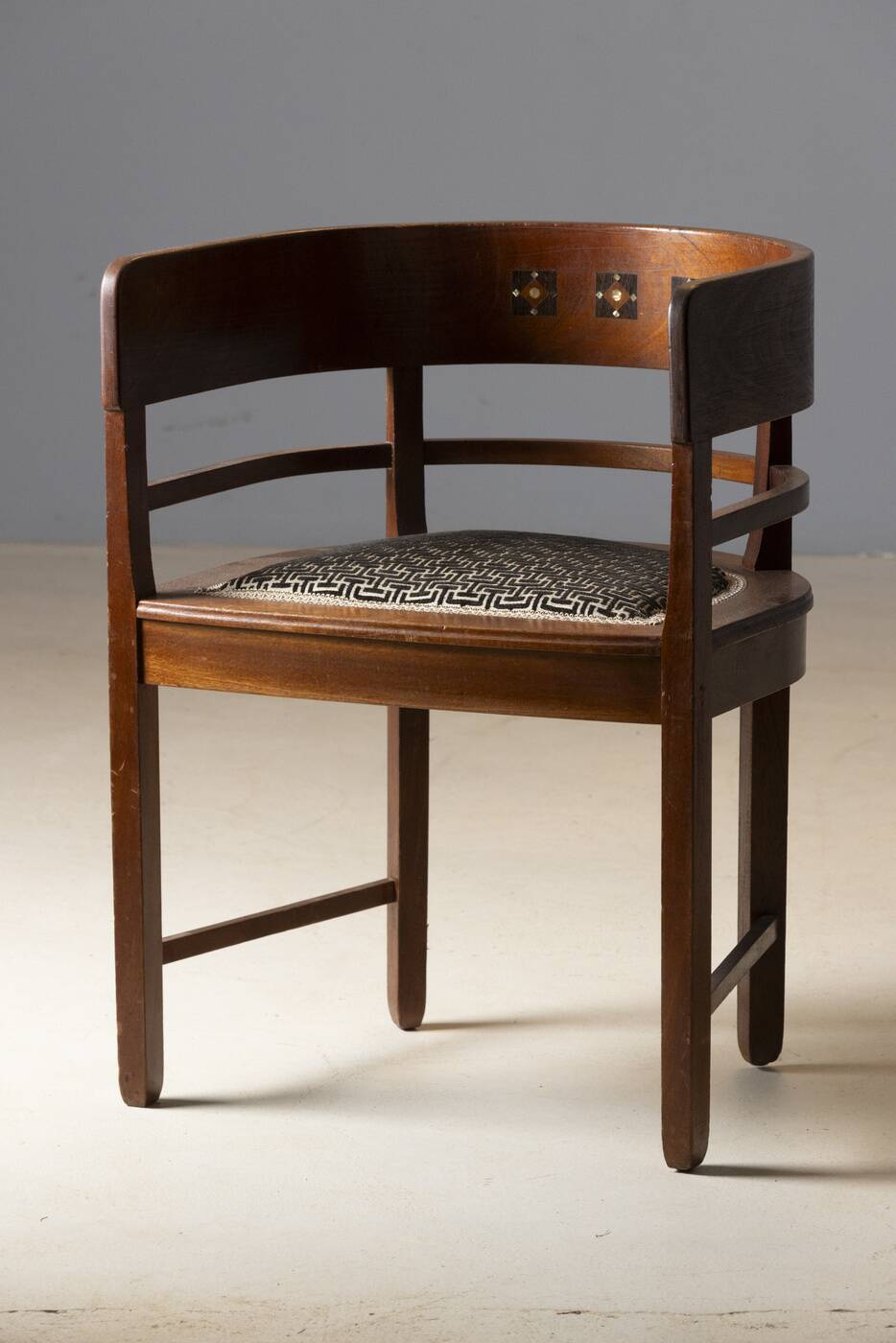 Central European armchair from the early 20th century with an inlaid backrest.