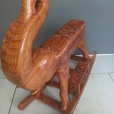 Decorative rocking elephant in carved exotic wood.
