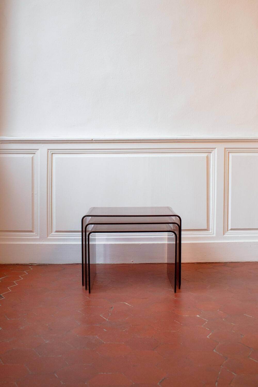 Vintage trio of nesting tables in smoked plexiglass by Michel Dumas, year.