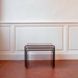 Vintage trio of nesting tables in smoked plexiglass by Michel Dumas, year.