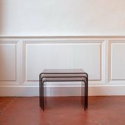 Vintage trio of nesting tables in smoked plexiglass by Michel Dumas, year.
