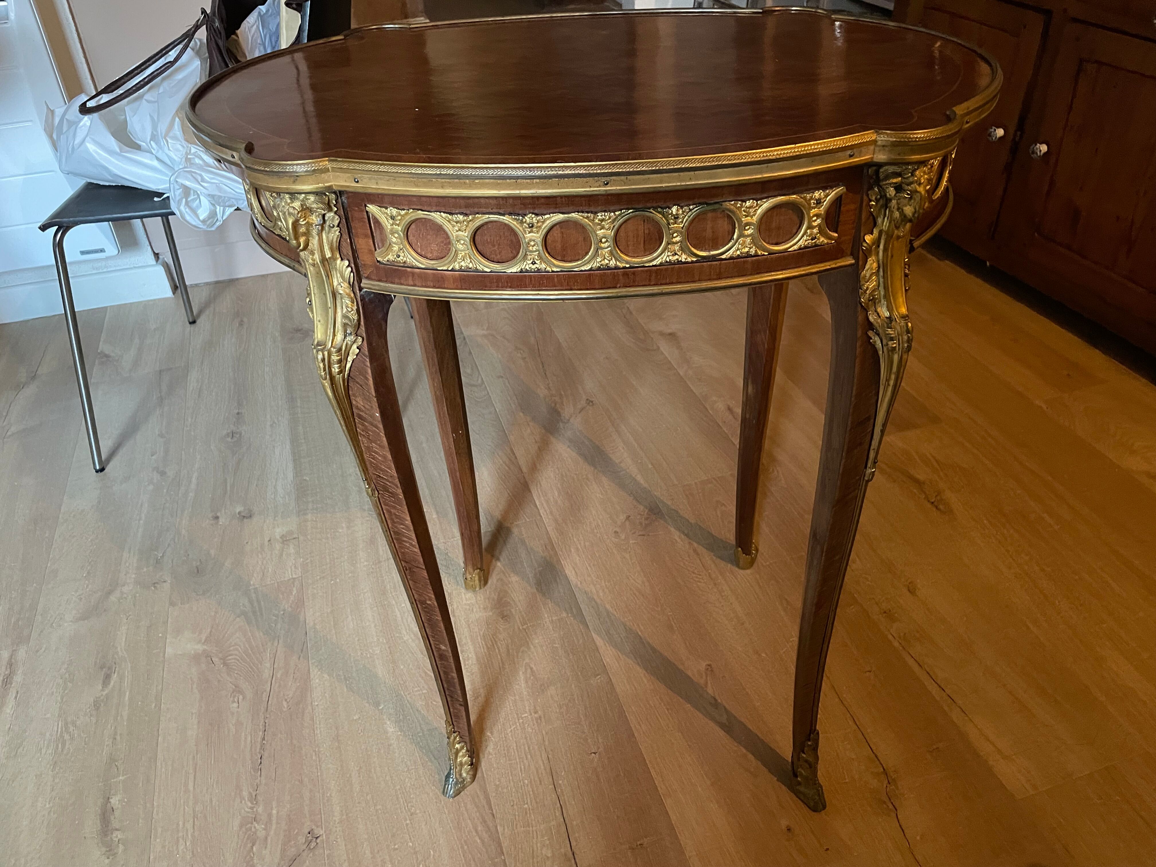 Living room table in Louis XV-Louis XVI transitional style with marquetry and bronze.