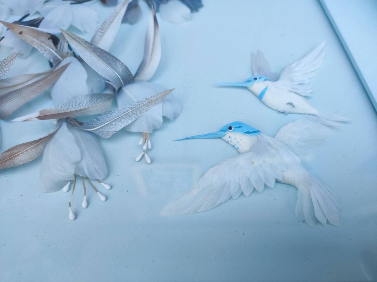 Two vintage paintings made with feathers, hummingbird motif