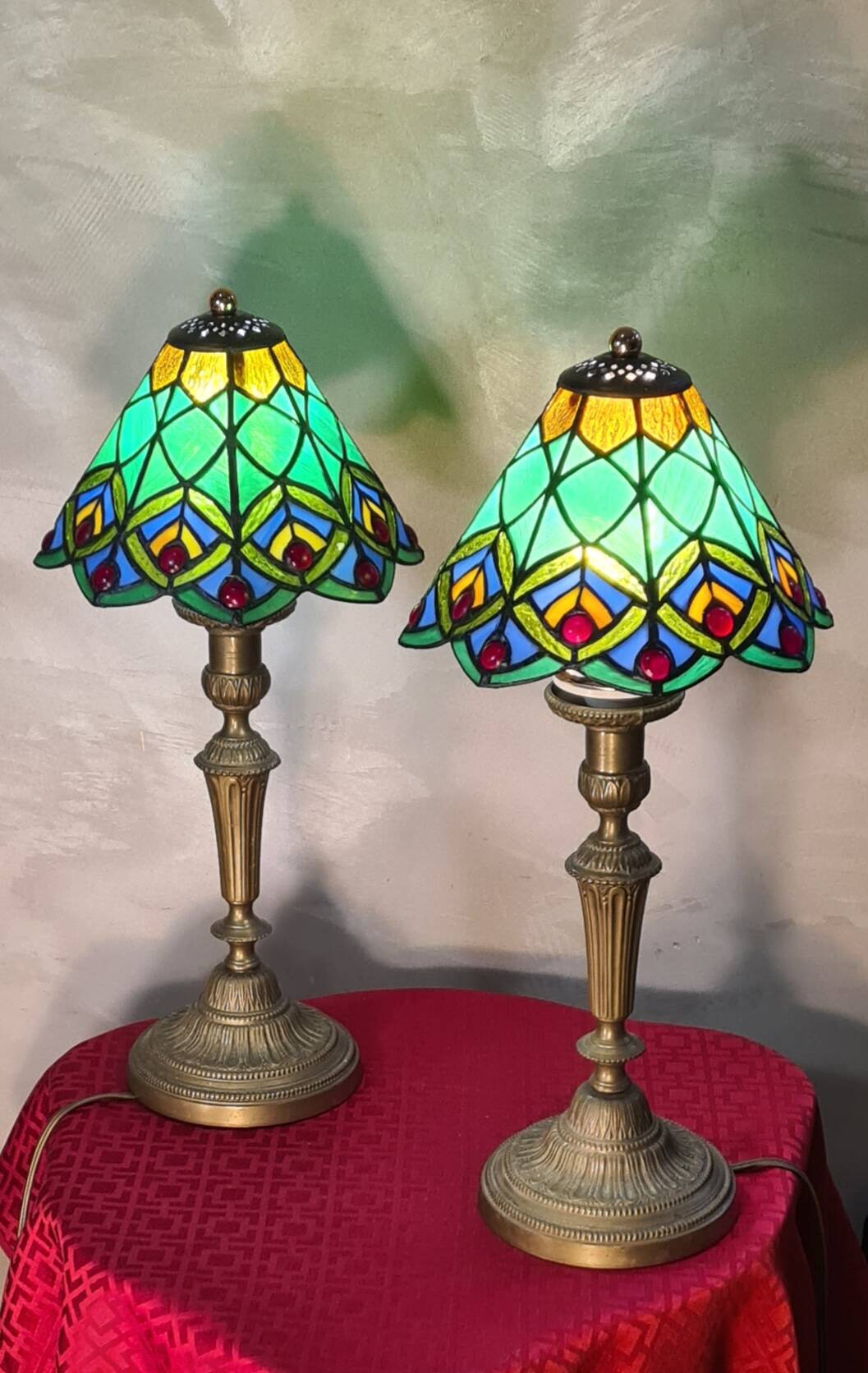 Pair of art nouveau bronze lamps, Tiffany-style glass lampshades