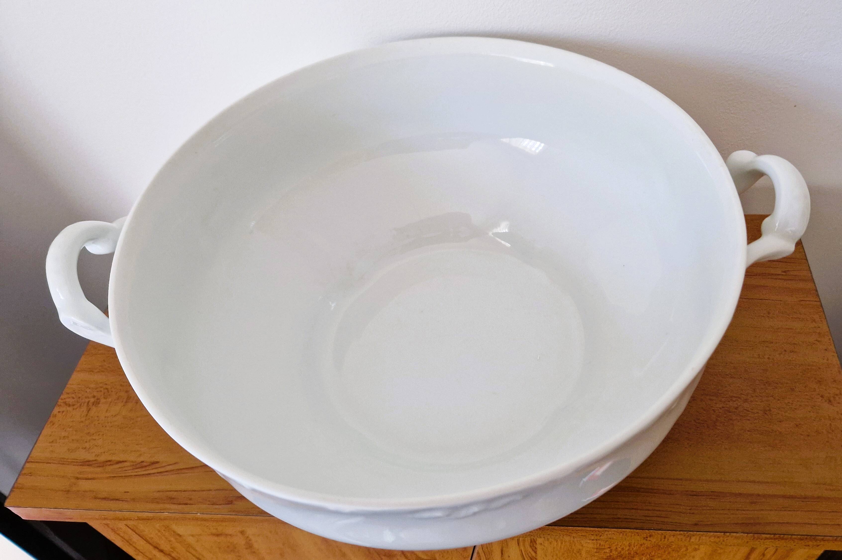 White porcelain soup tureen from Limoges with a vegetal scroll design.