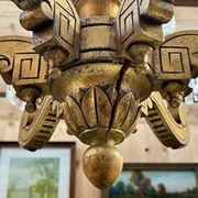 Golden wooden chandelier with crystal pendants from the 19th century.