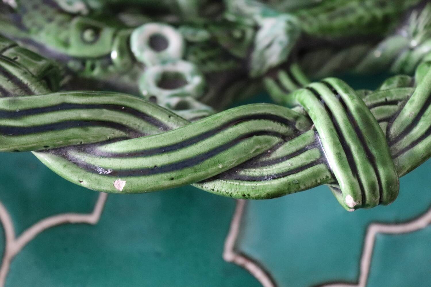 Antique woven basket in green glazed ceramic, fish decoration