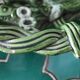 Antique woven basket in green glazed ceramic, fish decoration