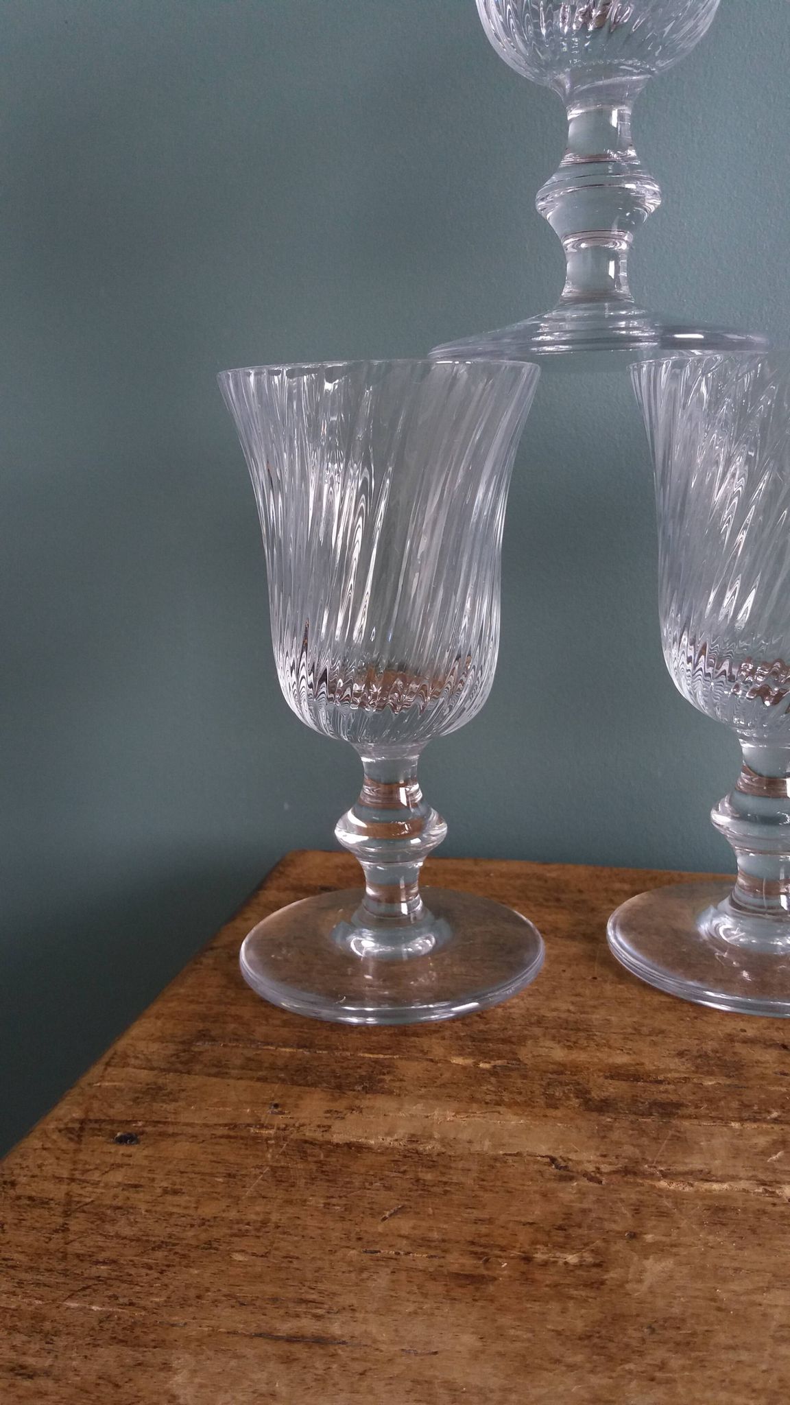 Ancient footed crystal glasses with relief twisted fluted goblets.