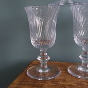 Ancient footed crystal glasses with relief twisted fluted goblets.