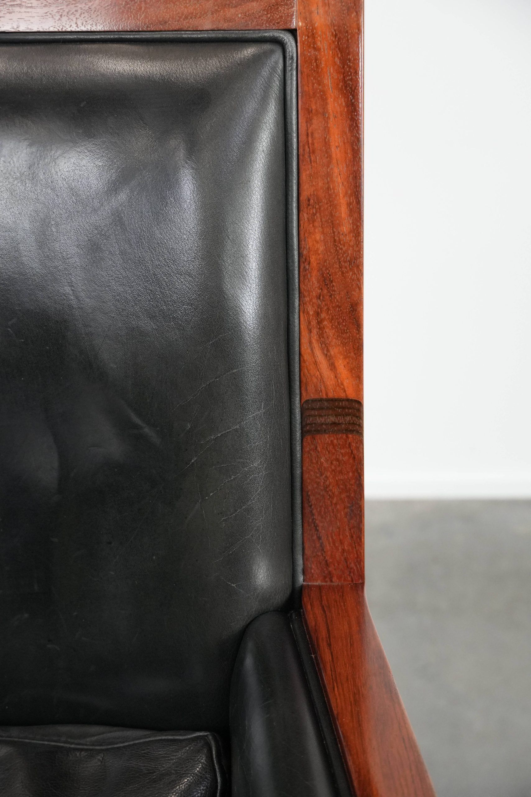 Black cowhide leather and wooden Art Deco design armchair