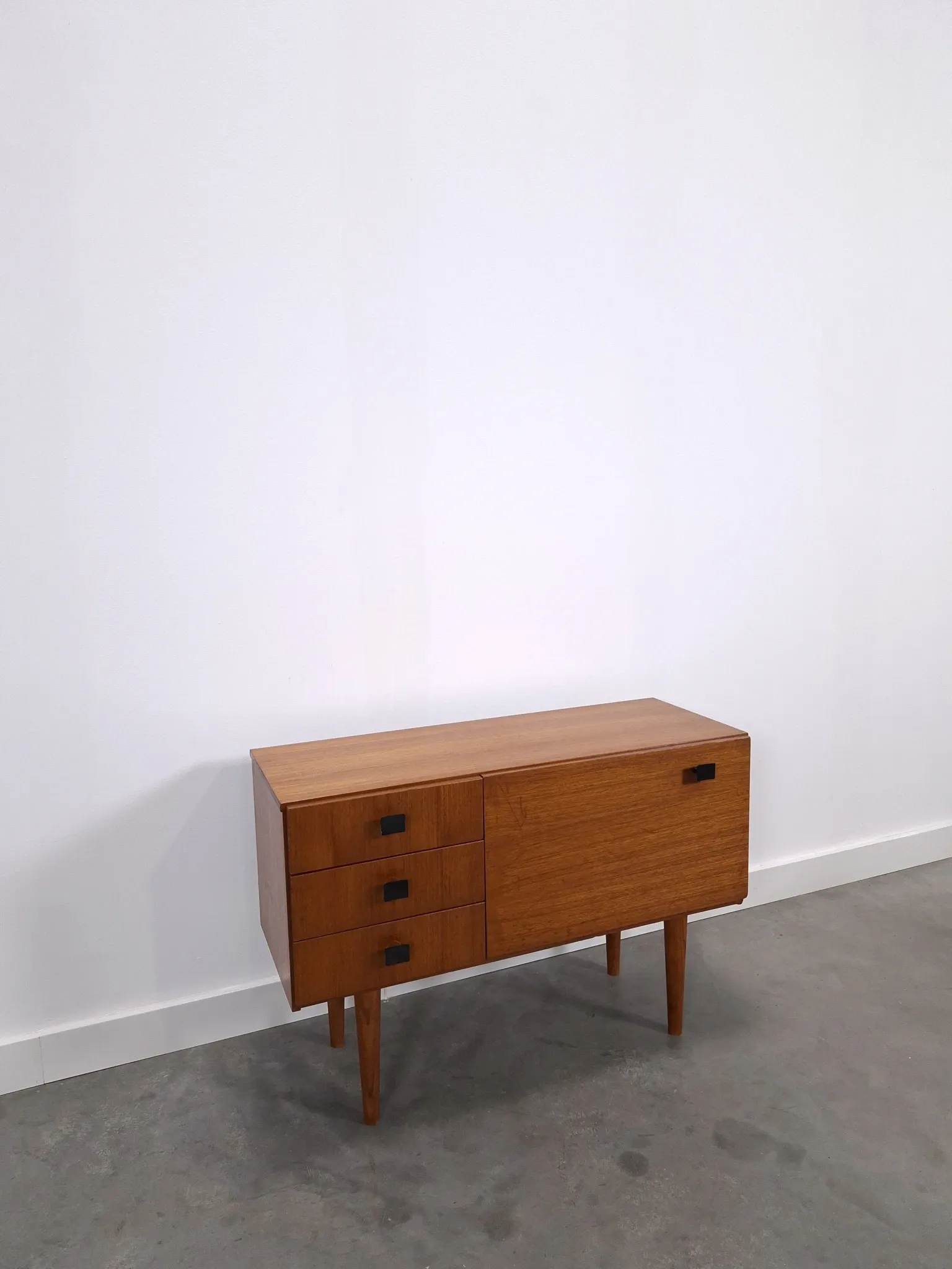 Vintage small teak cabinet with drawers, flap and black handles, hallway cabinet.