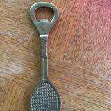 Bottle opener, opens bottle in golden brass shape of racket design and vintage