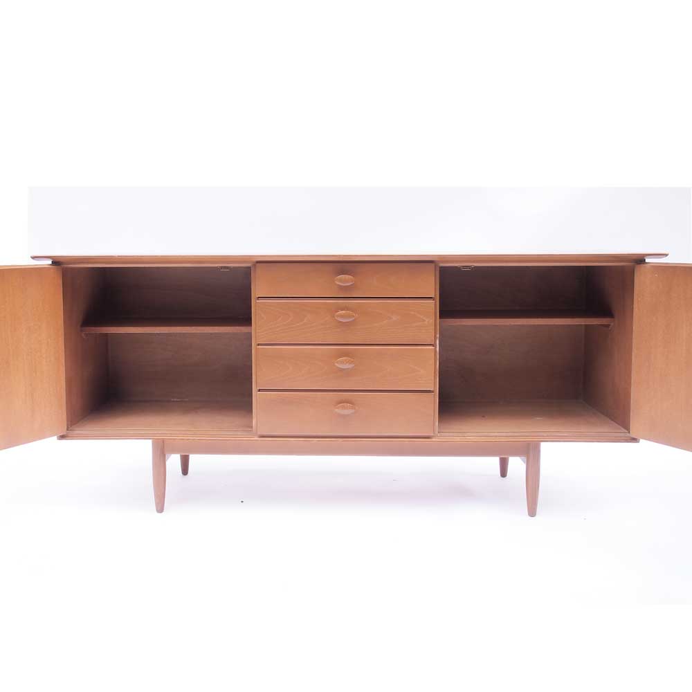 Vintage Scandinavian sideboard with an overflowing top.