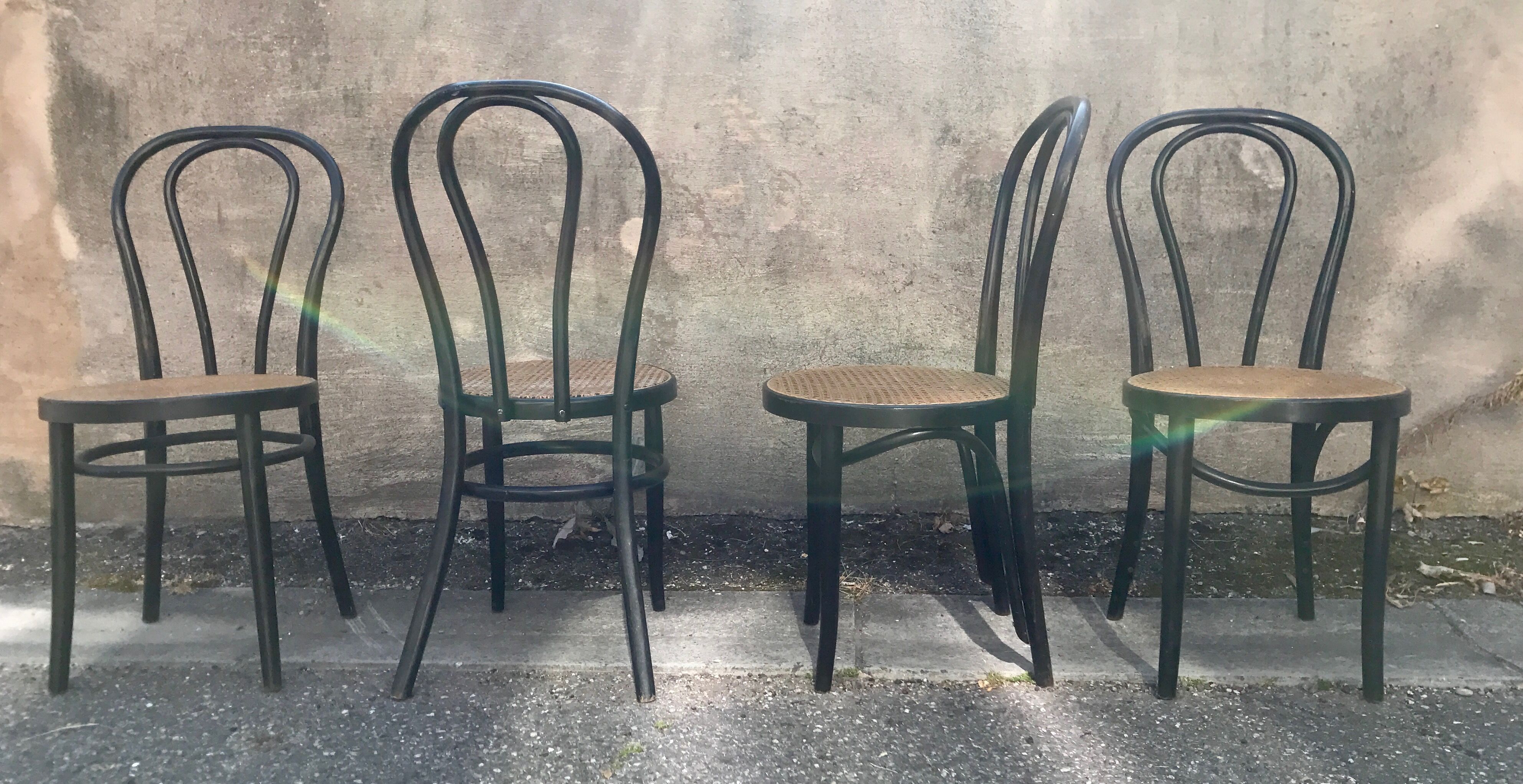 Two pairs of black 50s chairs - number 18 - cannée