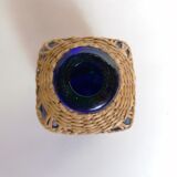 Blue bottle covered with wicker
