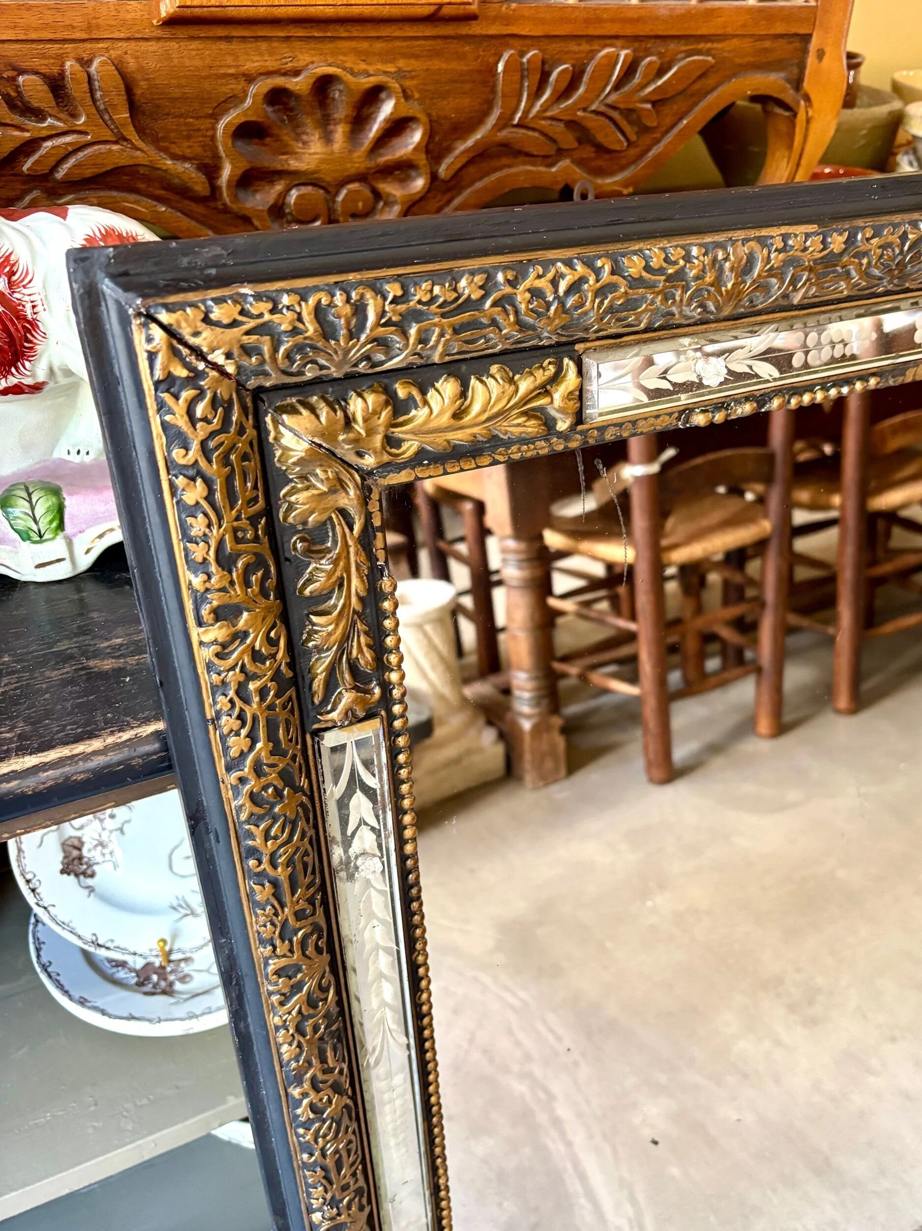 Rectangular Napoleon III mirror in moulded black and gold wood with engraved mirror decoration.