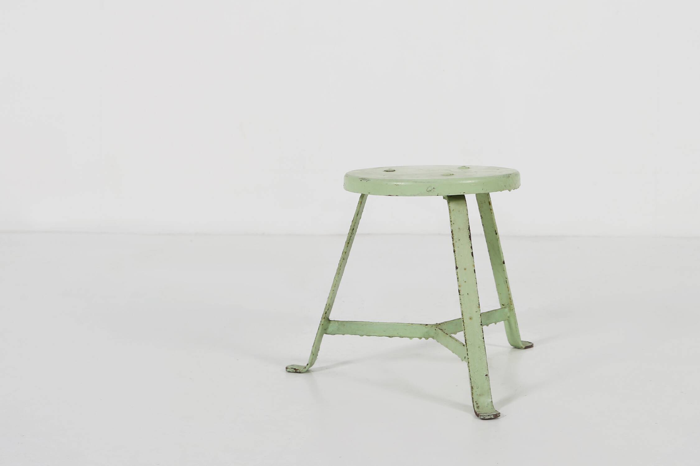 Industrial green painted stool with steel base and wooden top, France 1930s