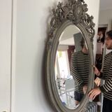 Beveled oval mirror in wood and stucco