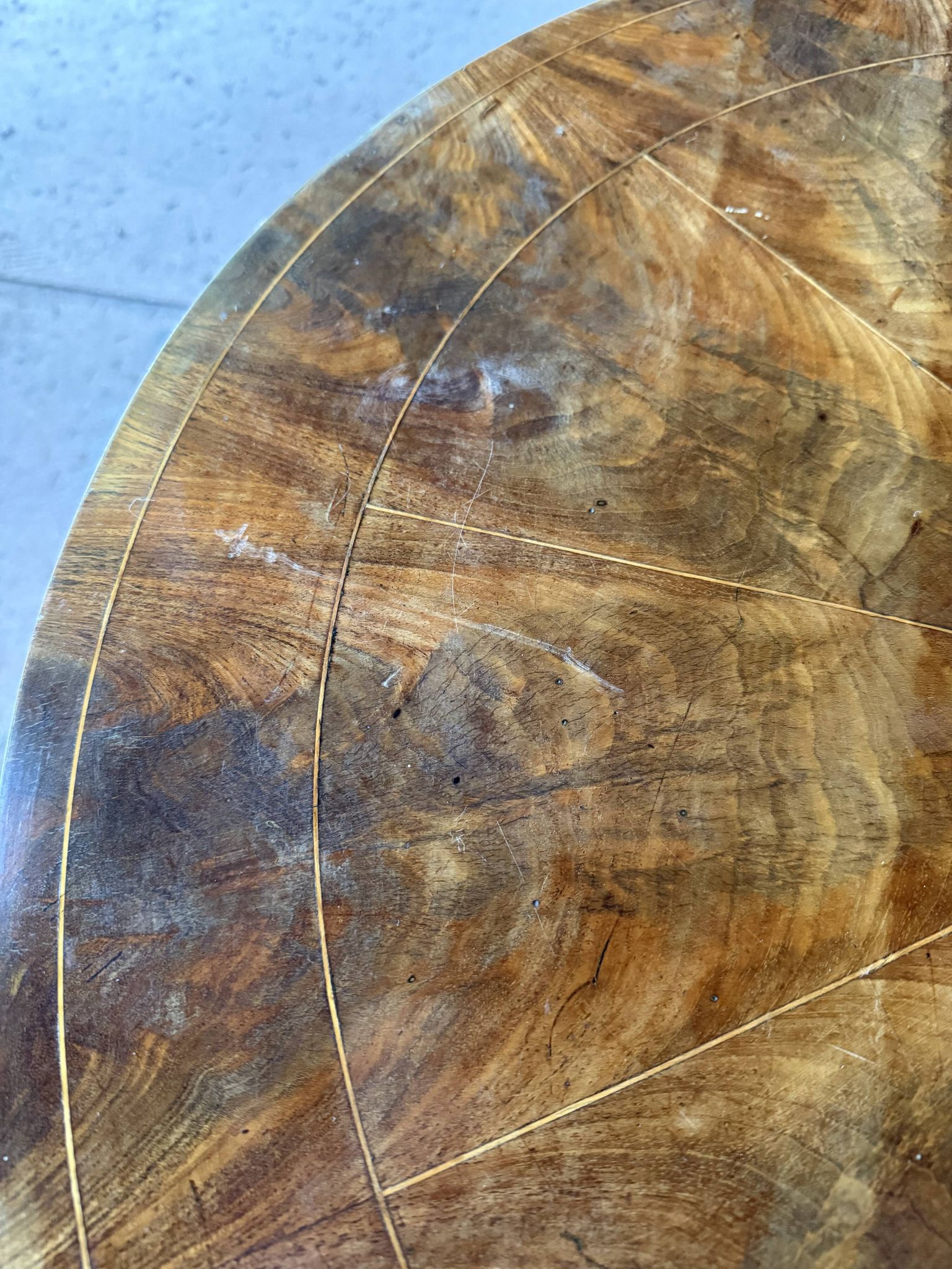 Antique round table with floral details.