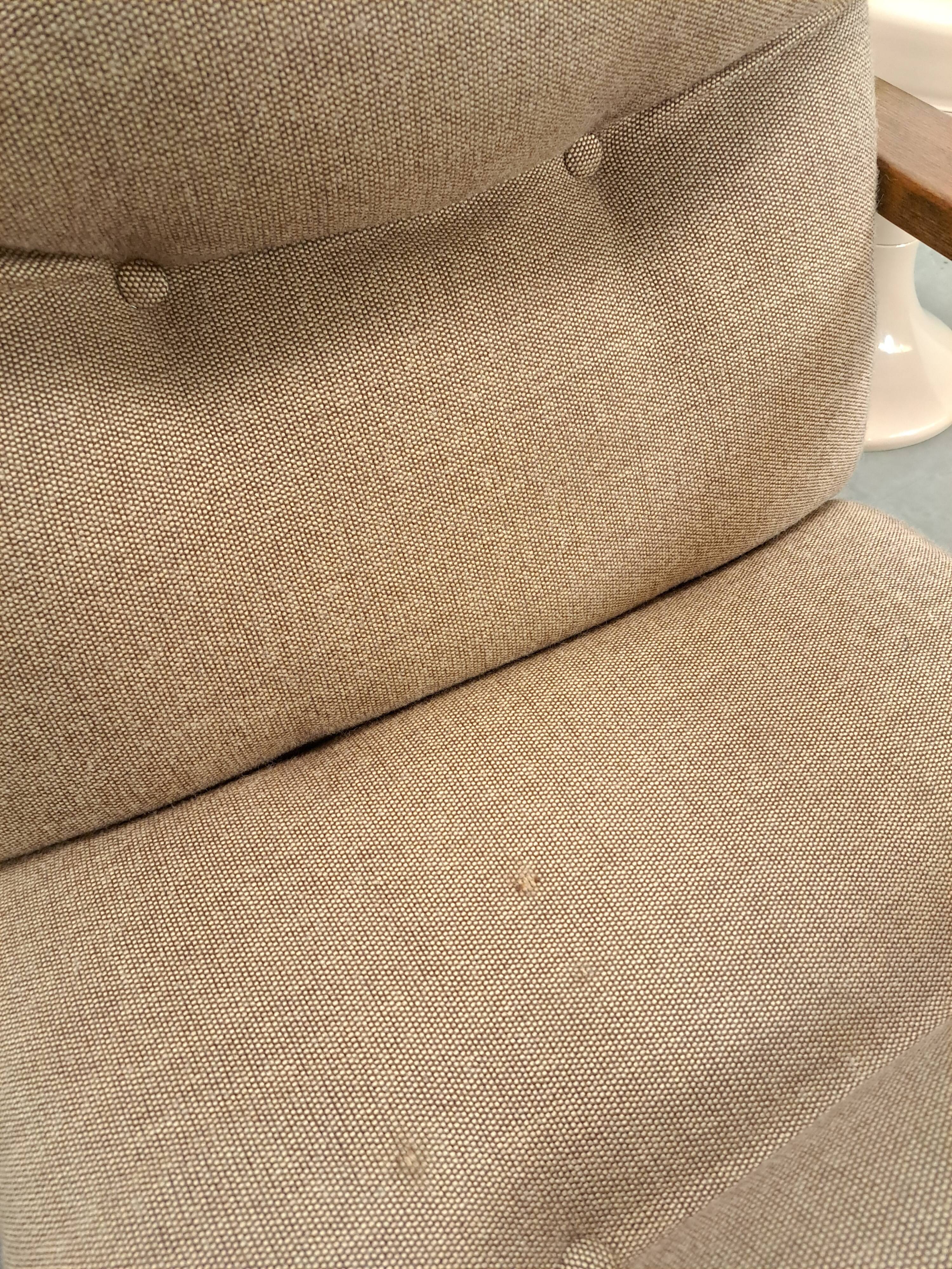 Brown-grey armchair with an oak frame.