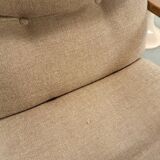 Brown-grey armchair with an oak frame.