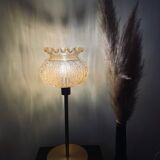 Table lamp with an antique crowned globe and a golden base