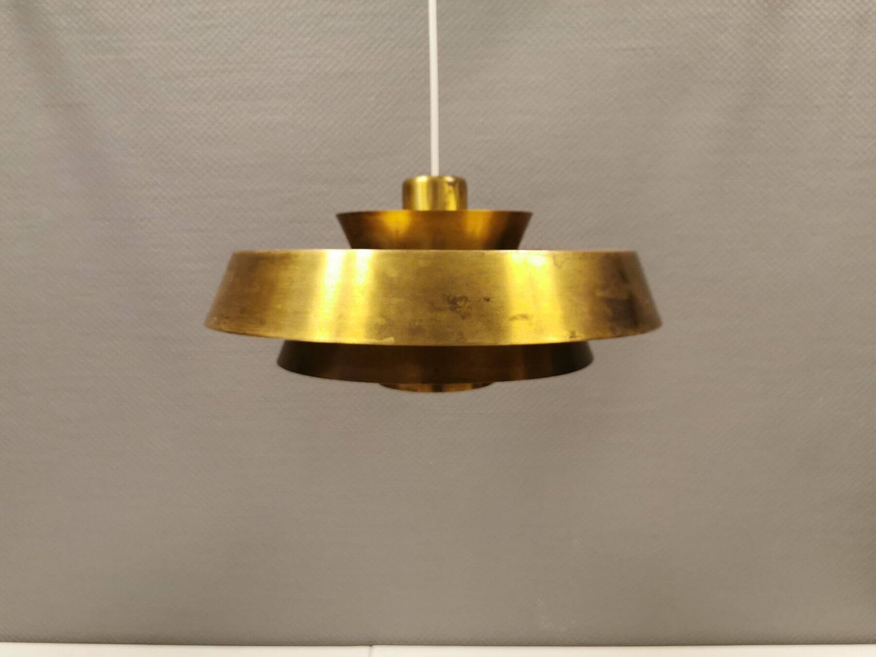 A mid-century Danish hanging lamp in solid brass by Jo Hammerborg for Fog & Mørup.