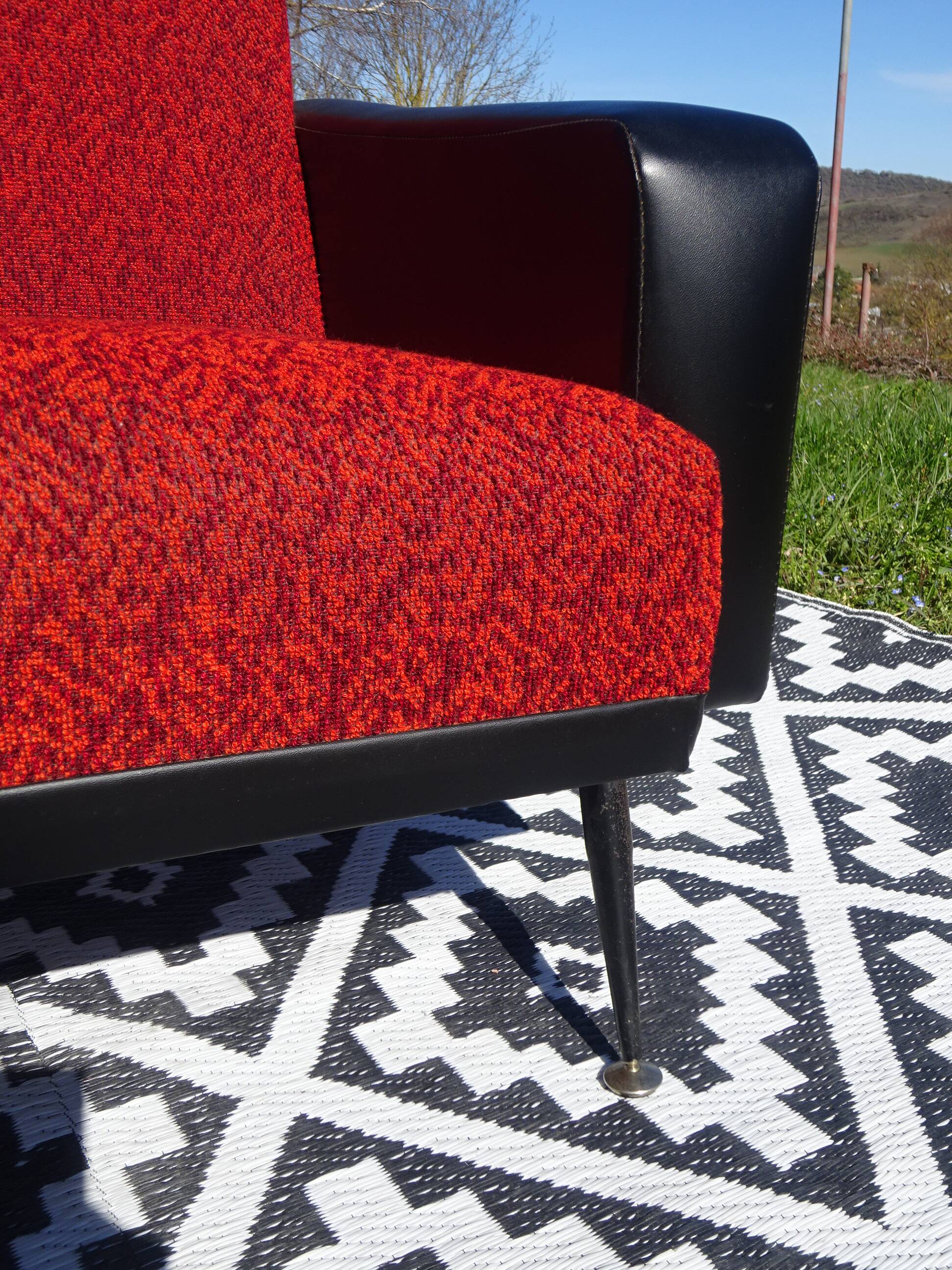Vintage armchairs in red and black faux leather, the pair.