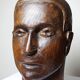 Monoxyle wood sculpture of a man's head, vintage craftsmanship from the 1950s.