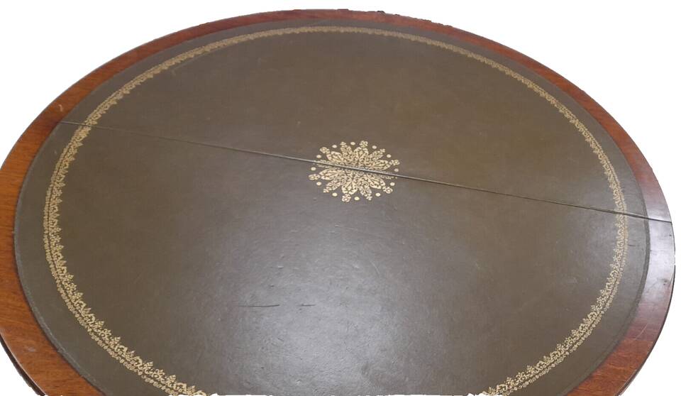 English style round table with green and gold leather top, quadripod with brass claws