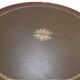 English style round table with green and gold leather top, quadripod with brass claws