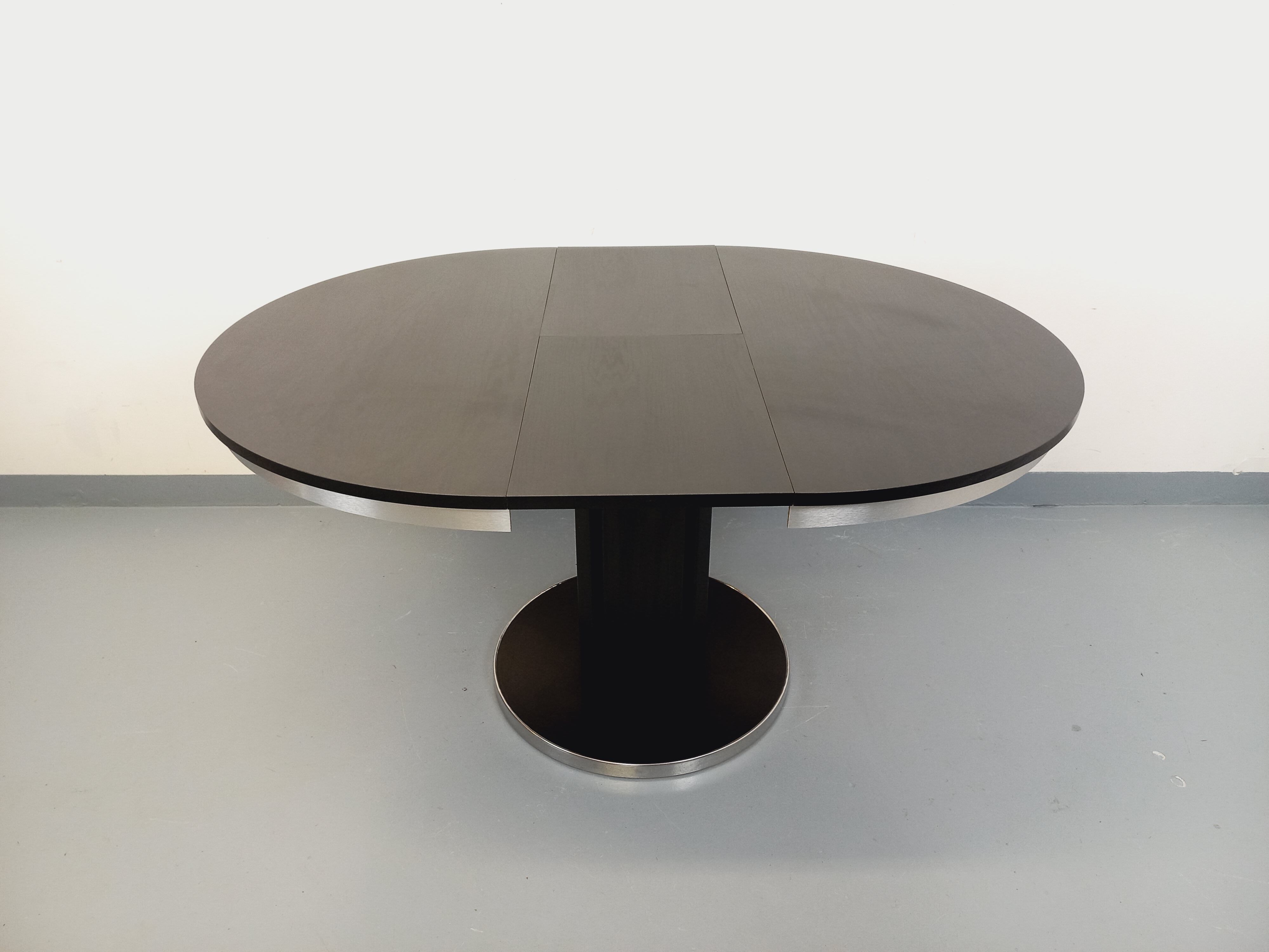 Vintage dining table in melamine with a black wood effect and chrome metal.
