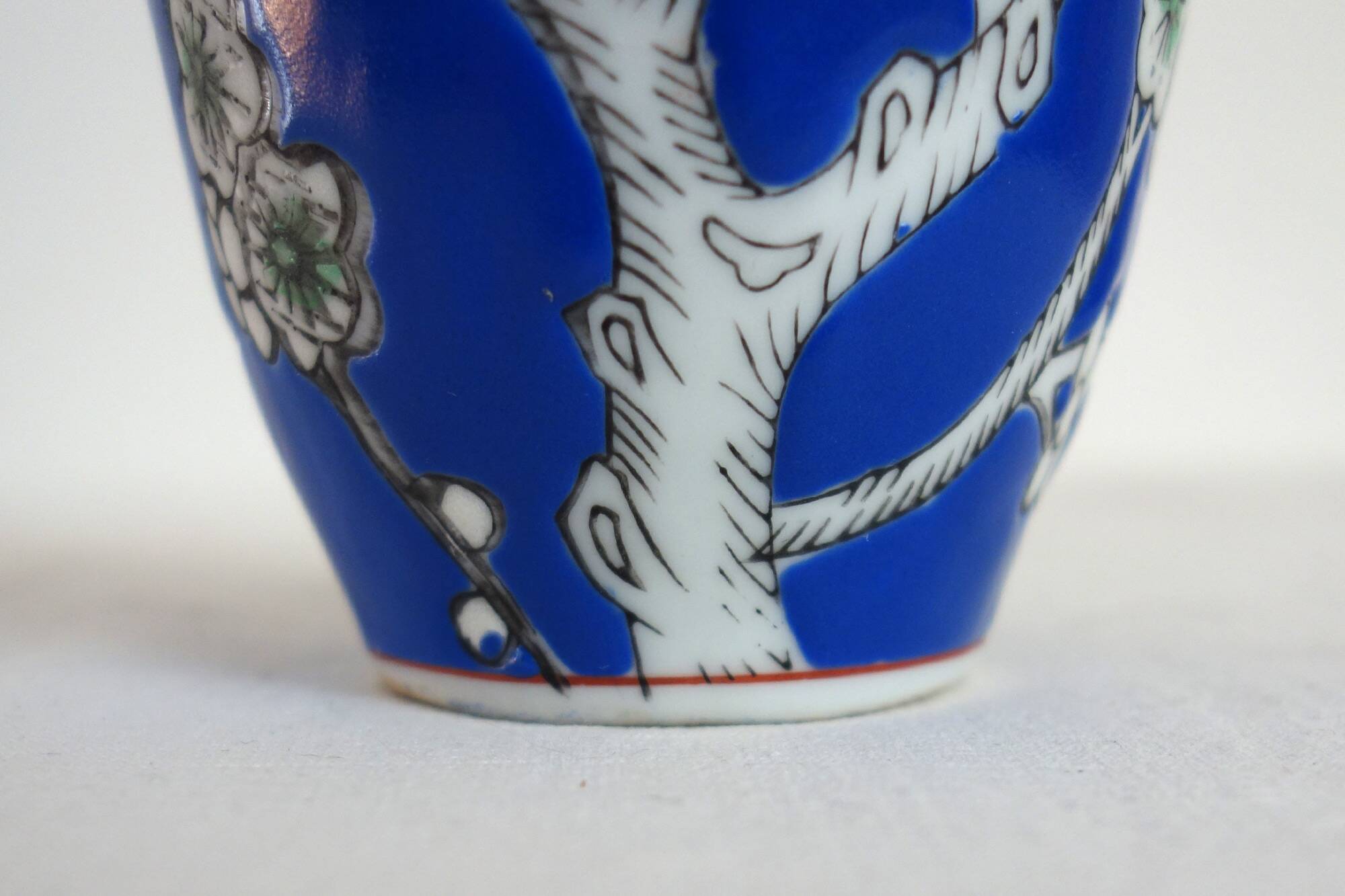 Old blue vase with vintage porcelain cherry blossoms